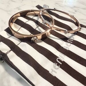 Henri Bendel rose gold toned bracelet set with silver stone accents.